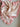 Raised Stripe Frill Blanket Sweatpea knitted in a sweetpea stripe on a snow knit base featuring a sweetpea frill edge shown in a flat lay view.