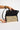 Reema Bag Black open view of the woven rattan crossbody bag showing its interior and magnetic snap closure details.