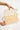 Reema Bag Off White open view showing the interior compartment and magnetic snap closure of the woven rattan crossbody bag.