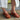 Revel Heel in cedar featuring a leather upper, leather lining, suede sole, and rubber outsole, styled outdoors.