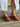 Revel Heel in cedar featuring a leather upper, leather lining, suede sole, and rubber outsole, styled outdoors.