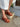 Side view of the Revel Heel in cedar showcasing a leather upper, leather lining, suede sole, and durable rubber outsole.