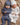 Two sleeping twin babies wearing soft ribbed cotton onesies and matching beanies.