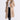Woman wearing a faux fur beige coat with fur collar on a white background