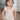 Ruby Romper in beige featuring a smocked bodice, ruffle straps, and a bubbled shape.
