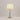 Illuminated Sage Ball Lamp showing a glowing natural fabric shade and a stacked spherical sage green base.