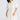 Close-up front view of the Sandra Dress in Porcelain highlighting its contrast topstitching and elbow-length sleeves.