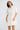 Close-up front view of the Sandra Dress in Porcelain highlighting its contrast topstitching and elbow-length sleeves.