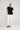 Sandra tee black featuring a round neckline, turn-back short sleeves, and a curved hem, styled in a relaxed front pose.