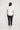 Sandra Tee in white back view, showing the relaxed silhouette, curved hemline, and turn-back short sleeves.