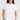 Sandra Tee close-up view highlighting the round neckline, peached jersey fabric texture, and turn-back short sleeves.