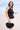 Santana Bag Black campaign view highlighting the handwoven statement bag ideal for resort styling.