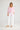 Seaside Top Candy Stripe styled with white trousers for an effortless resort-inspired look.