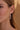 Lifestyle close-up view of a model wearing the sterling silver Sierra Earrings featuring a cascade design with blue topaz and citrine.