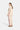 Woman wearing a beige outfit with pink accents on a white background