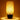 Squat Cylinder Lamp with brown ceramic base and natural shade turned on, warm accent lighting.