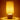 Squat Cylinder Lamp with white ceramic base and natural shade turned on, ambient table light.