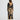 Woman wearing a long, patterned dress with a white background