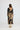 Woman wearing a long, patterned dress with a white background