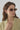 The Coco sunglasses in mocha cream featuring 90s oval frames styled on a model.