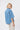 Back view of the Kireina Beth cord shirt in Mid Blue, highlighting the tailored box pleat and drop-shoulder short sleeves, stocked at lifestyle department store The White Place.