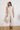 Kireina Freya Jean in Heart Sand at boutique stockist The White Place. Wide-leg neutral denim pants styled as a co-ord outfit.