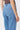 Close-up back view of the Kireina Harper Jean in Ribbed Mid Blue showing the logo patch pocket detail. Available at The White Place Australia.