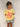 Organic cotton reversible kids t-shirt in yellow with pink collar trim and Island Home front graphic.