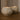 Side profile view of burning Travertine candles showcasing their natural stone patterns and warm glow.