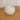 Top view of an unlit Travertine candle in a solid natural stone jar showing the white soy wax and single wick.