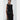 Woman wearing a black sleeveless dress with white trim on a white background
