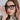 Black polycarbonate reading glasses with bold square frames and retro styling worn by a model.