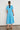 Valour Dress Lagoon shown from the back featuring a drop-waist silhouette and midi length in a vibrant lagoon colour.