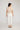 Wayfarer Pant White featuring back patch pockets and a raw hem edge viewed from the back.