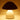 White Squat Mushroom Lamp turned on, glowing terracotta and metal accent light.