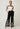 Willow Linen Embroidery Pant Black movement view featuring a breathable linen-viscose blend fabric and wide-leg silhouette.