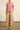 Full length front view of a model wearing the Yonder Top in floss pink, showcasing the relaxed silhouette, square neckline, vertical pin tucks, and 100% ramie fabric.