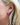 Zinnia Flower hoop earring featuring a bold pink enamel flower design worn by a model.